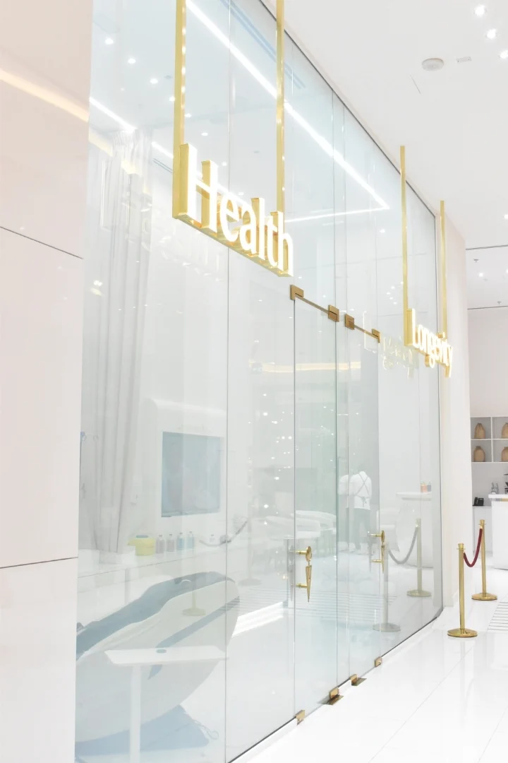 Glass treatment-room doors with gold lettering at My London Skin Clinic