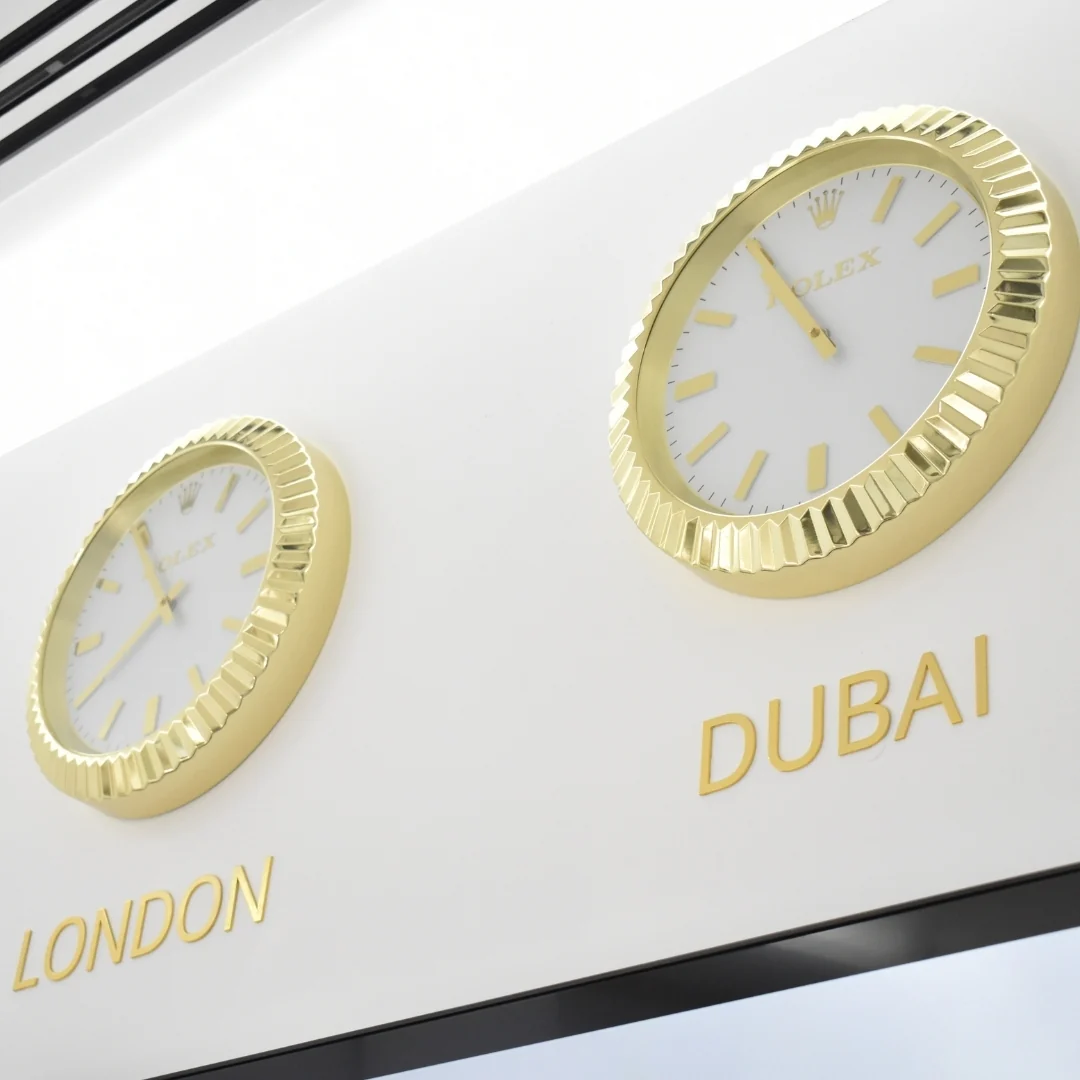 Gold clocks marked London and Dubai in the parent clinic